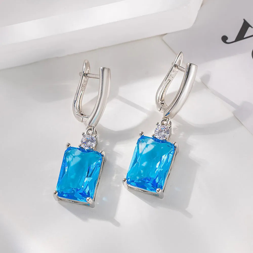 Square geometric copper earrings with gold or silver electroplated finish showing quadrilateral shape.