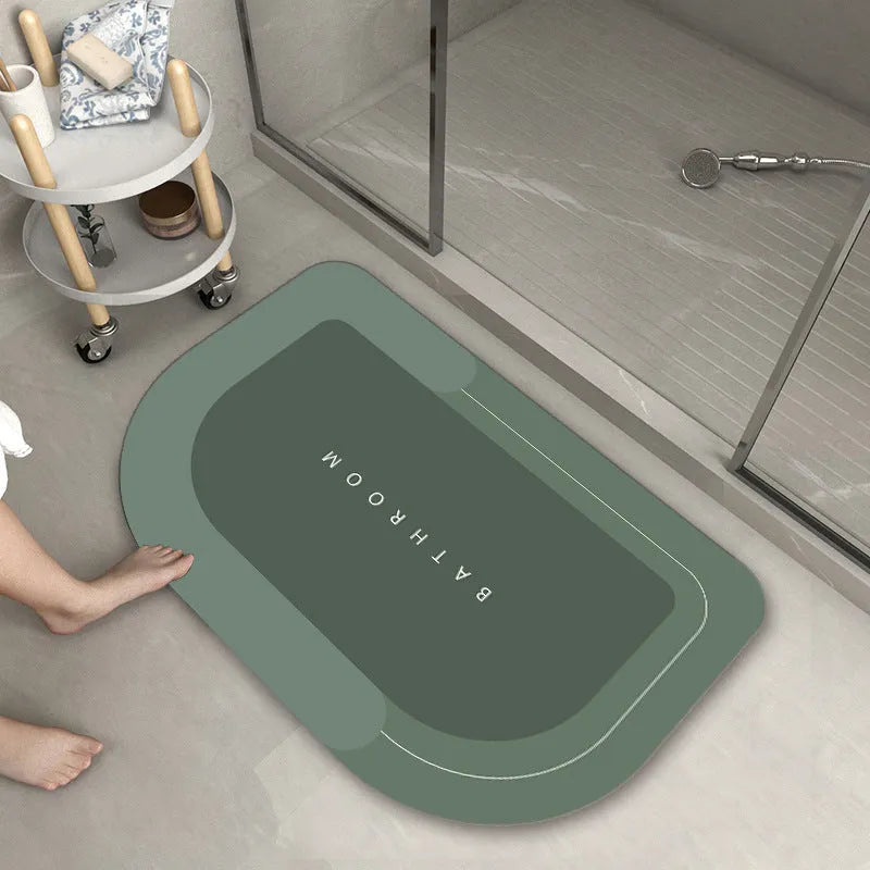 Soft blue oval bathroom floor mat placed on tiles beside a bathtub.