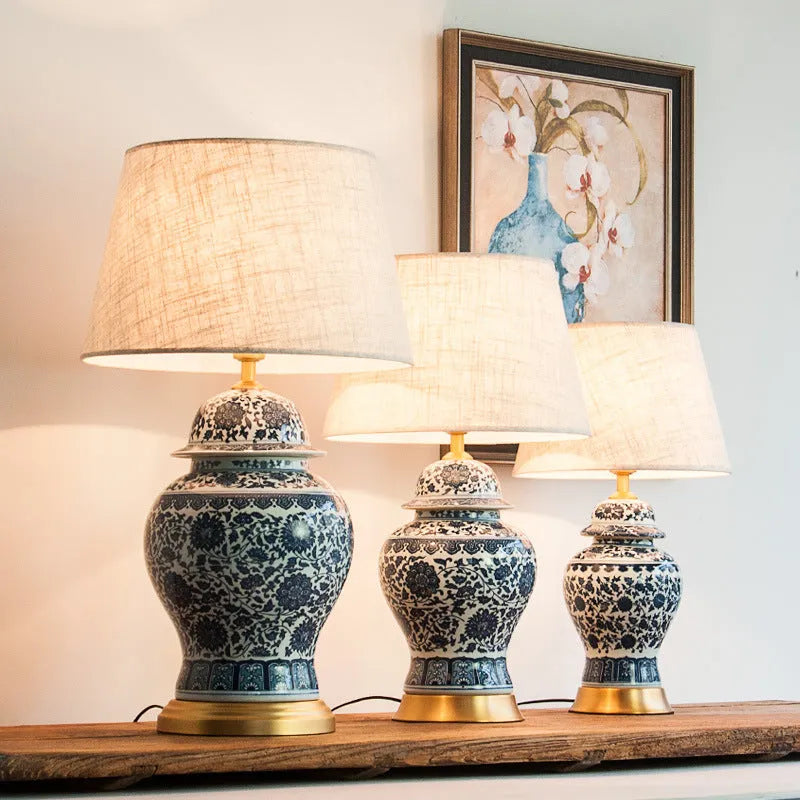 Handmade blue and white Chinese porcelain ceramic table lamp with copper base and fabric shade.