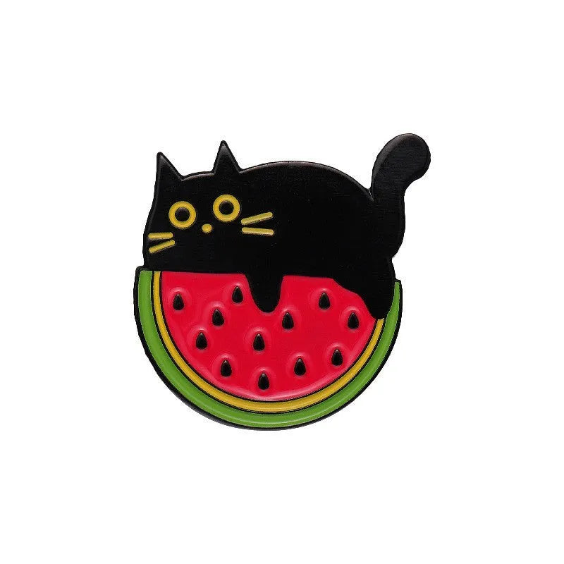 Colourful cartoon fruit design metal brooch pin on a fabric background.