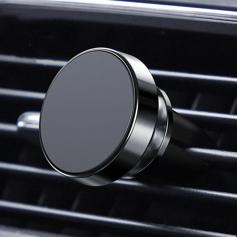 Magnetic car phone holder with aluminium alloy cradle shown in black, mounted on a car air vent.