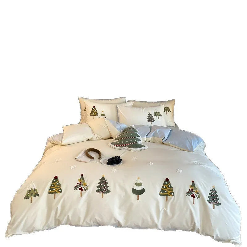 Four-piece cotton bedding set with Christmas tree towel embroidery pattern showing duvet cover, bed sheet, and pillowcases