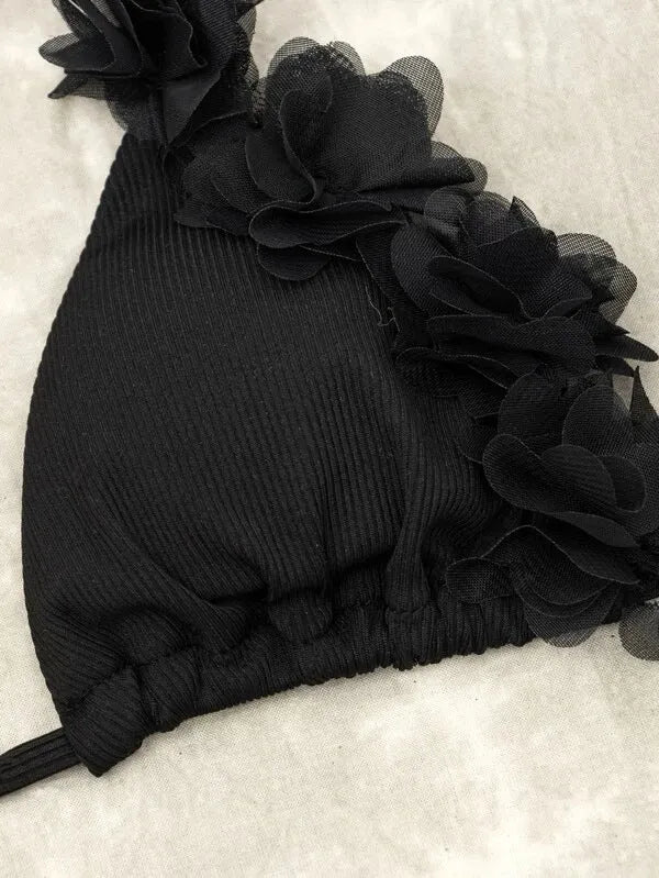 Black gathered swimwear set with matching top and shorts in European sizing