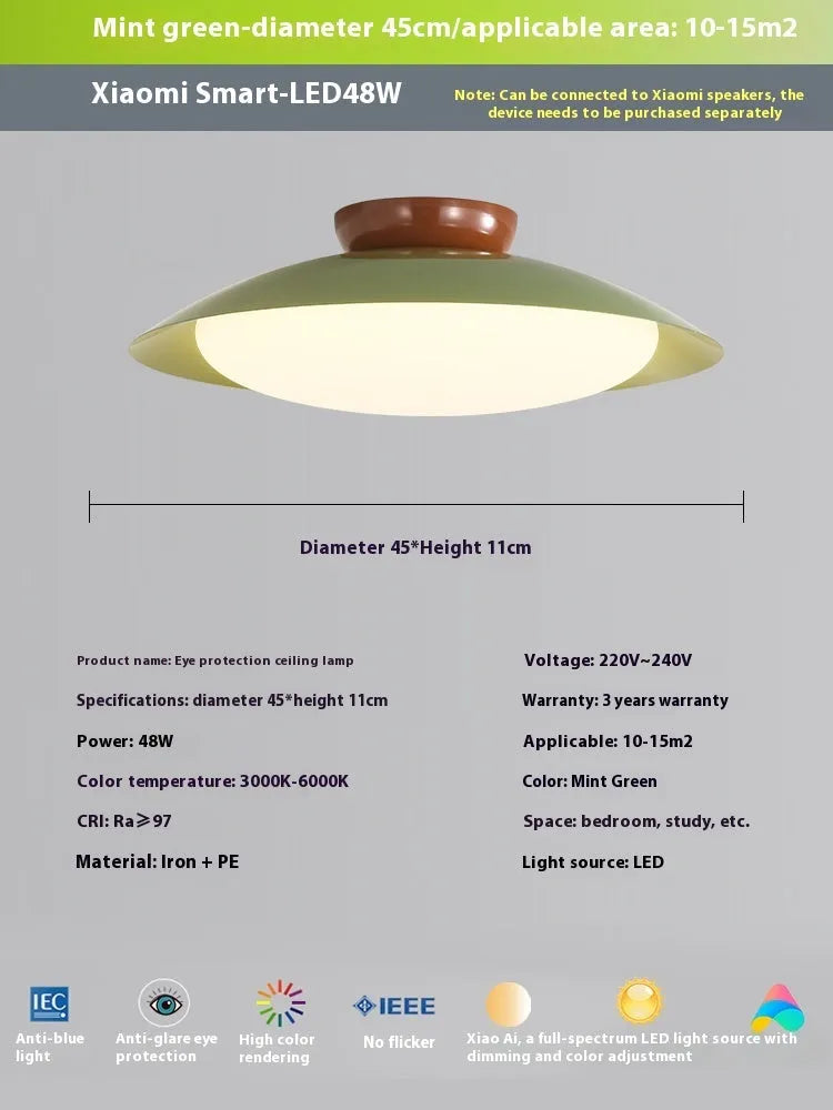 Modern flying saucer shaped ceiling lamp with an iron shade, shown in a cream yellow finish.