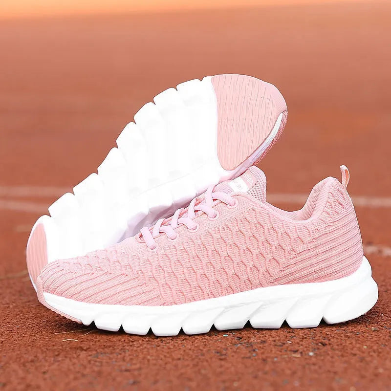 Women's running shoes in black, pink, or white with a detailed fly weaving upper and durable outsole.