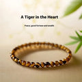 A geometric New Chinese style unisex bracelet made from round Tigereye stone beads.