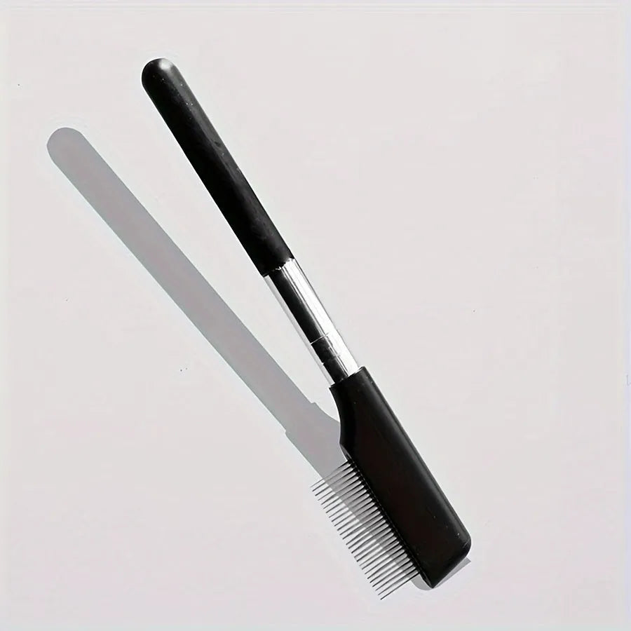 Black dual-sided pet grooming brush showing soft bristles for eyes on one end and a wider comb on the other