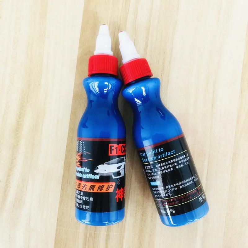 Small blue car wiping tool kit with scratch repair agent bottle and applicator sponge.
