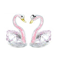 Crystal swan desktop ornament in red, blue, pink, or purple on a wooden surface.