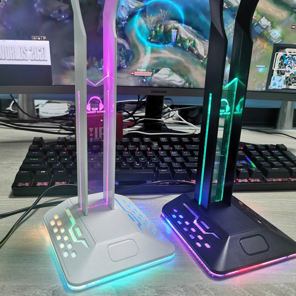 Acrylic RGB headset display stand with dual USB ports and colour-changing lights, holding a pair of headphones.