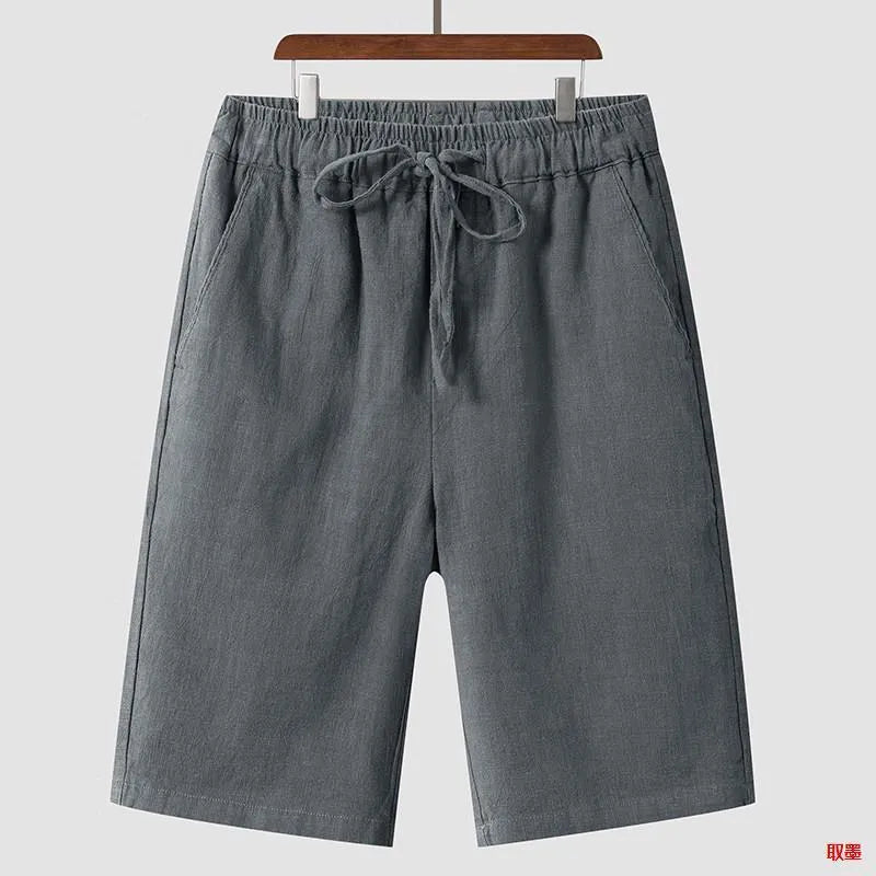 Man wearing beige linen cropped shorts with a loose fit and elasticated waist
