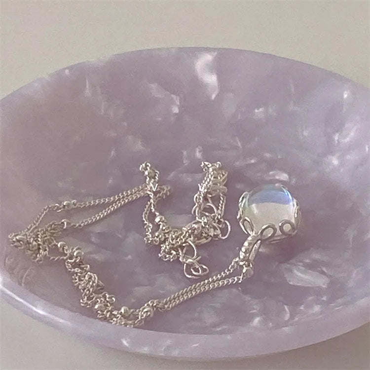 Silver necklace with geometrical ornamental stone pendant on an adjustable curb chain.