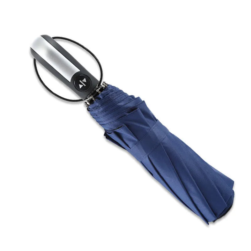 Large black triple folding automatic business umbrella with a steel frame and rubber handle, shown open.