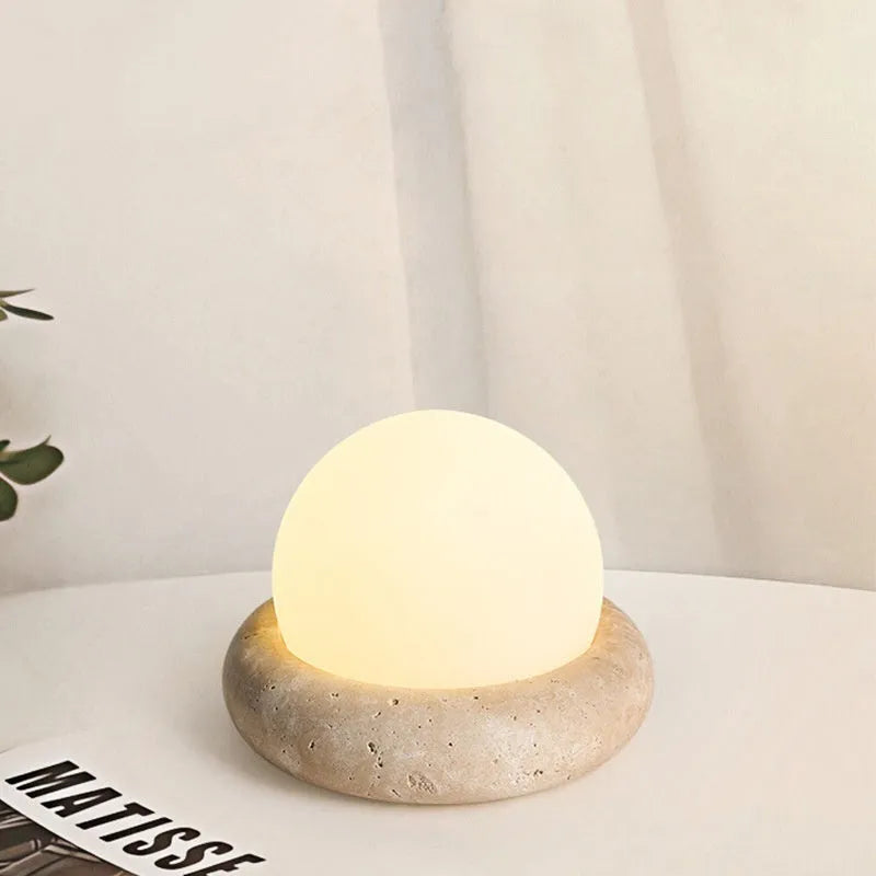 Cream colour bedside night lamp with remote control on wooden bedside table