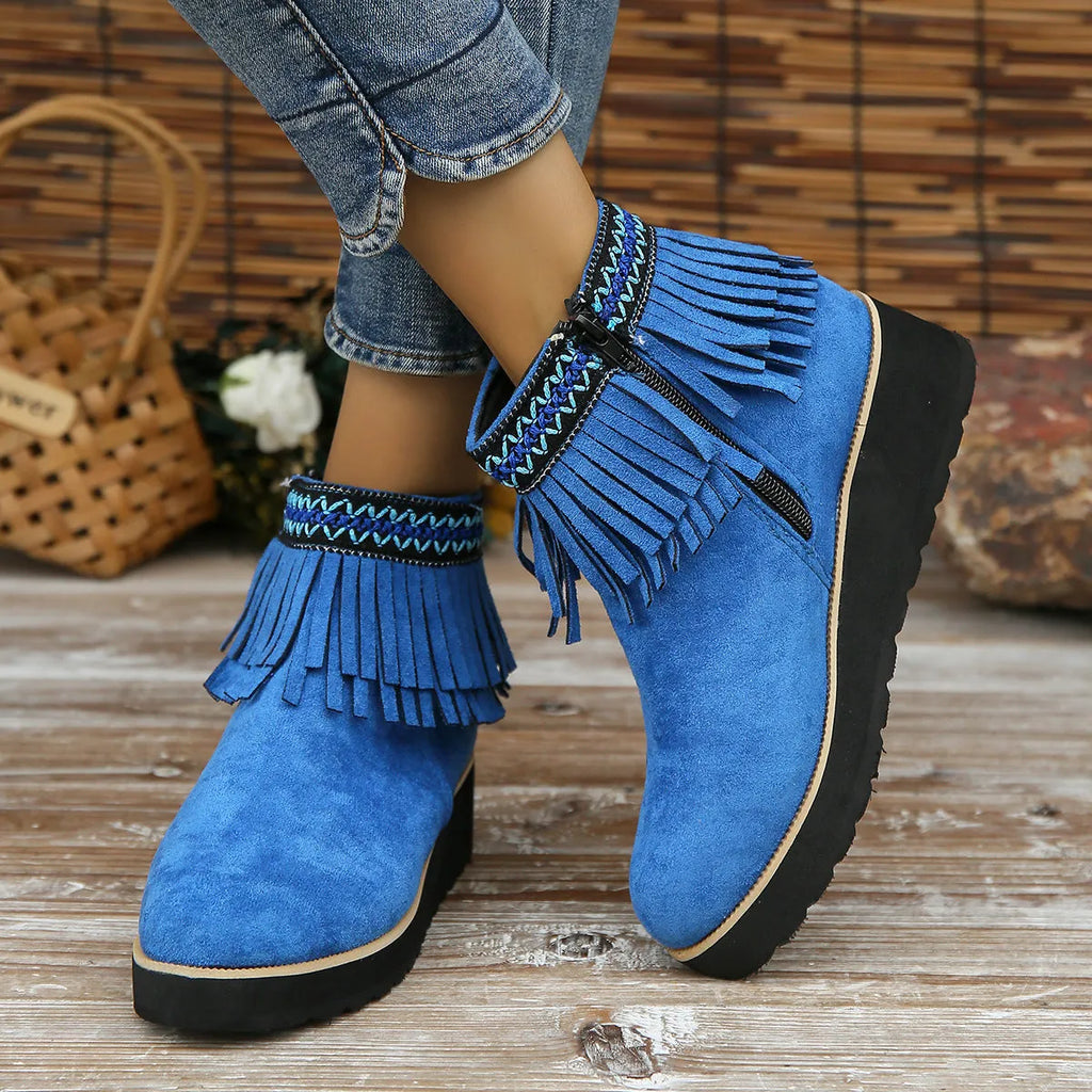 Women's dark brown suede ankle boots with a wedge heel, side zip, and decorative tassel detail.