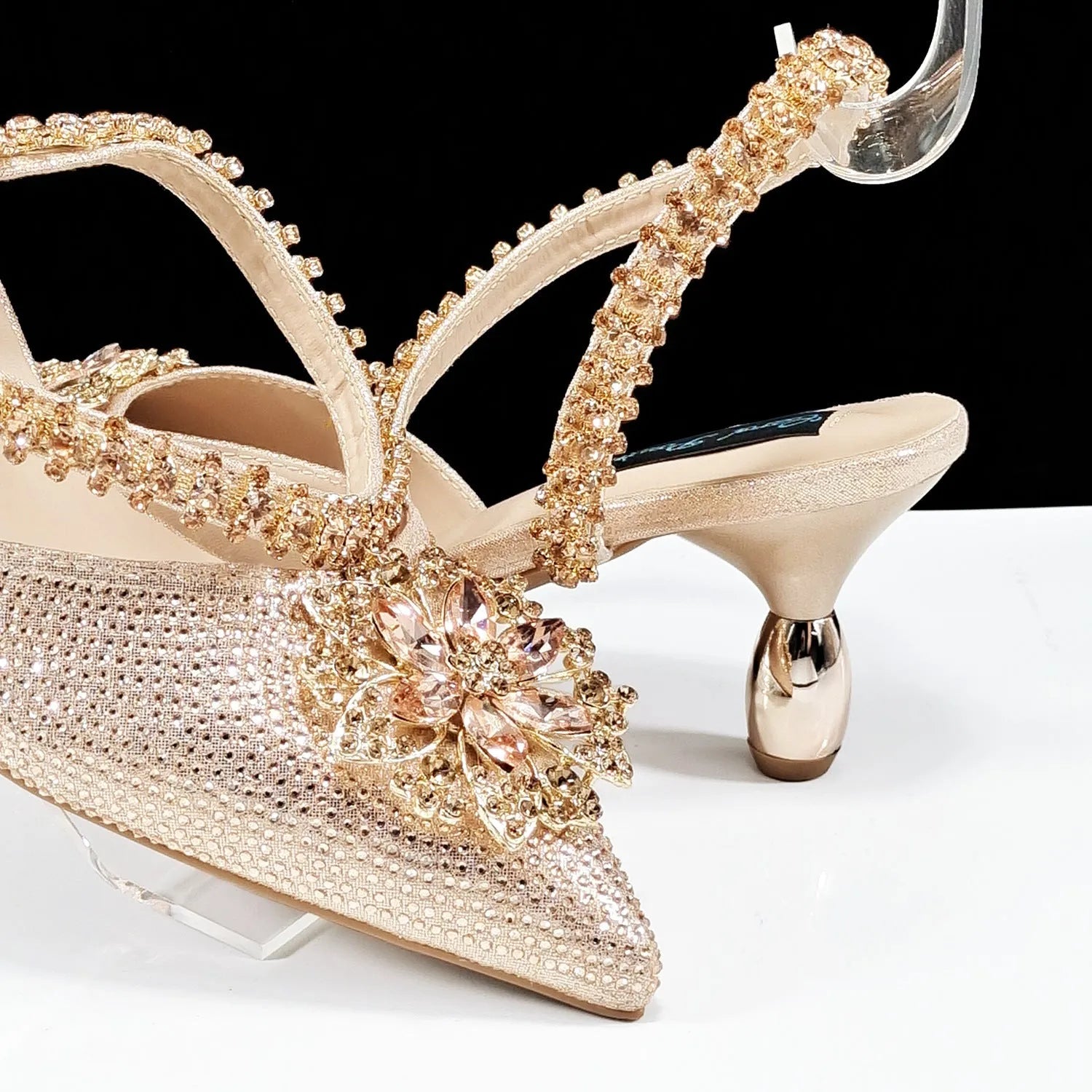 Women's black synthetic leather high heels with ankle chain and matching clutch bag with rhinestone flower decoration