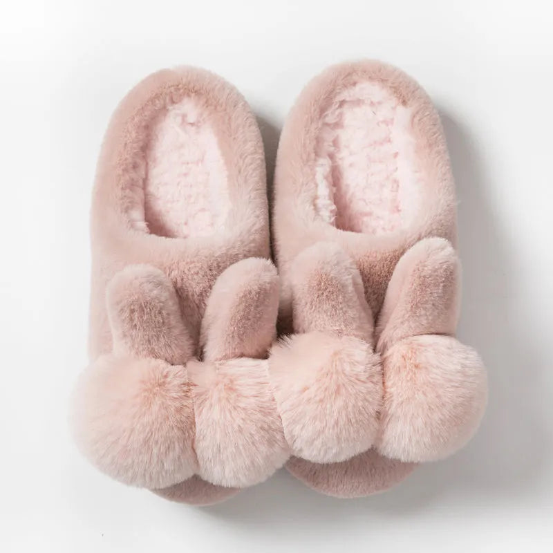Women's fluffy bunny slippers in pink with rabbit fur, high-top sleeve design, and sewn sole.