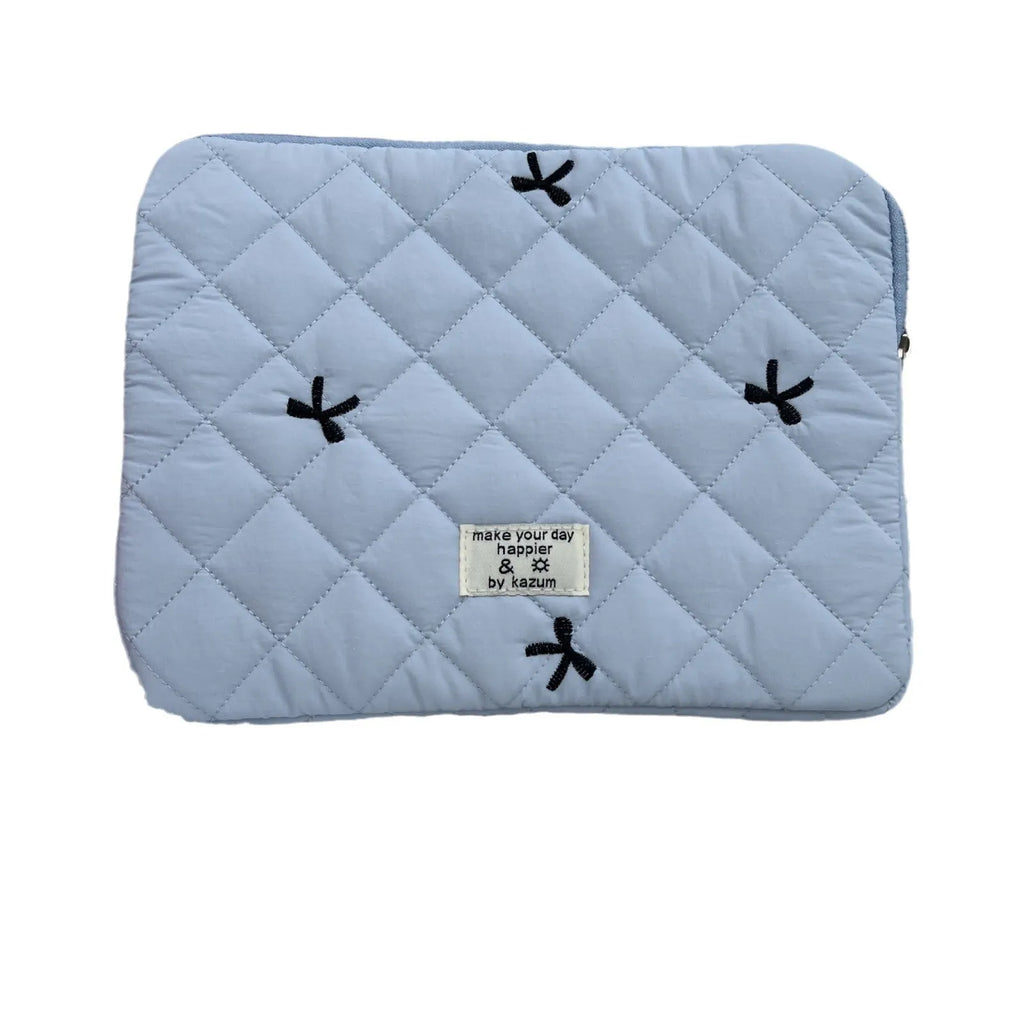 Cute white nylon laptop bag with a rhombus embroidered bow, shown next to a laptop.