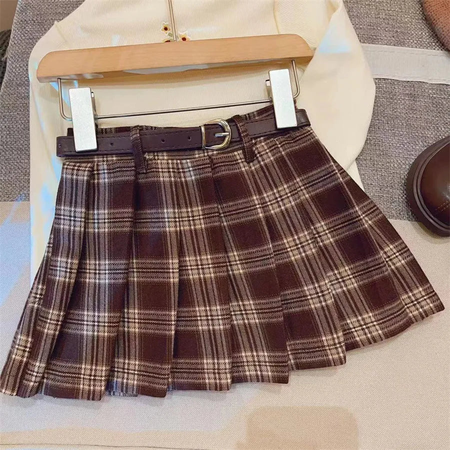 Girls' plaid pleated A-line skirt with an elastic waistband on a hanger.