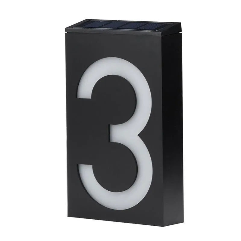 Solar-powered white LED house number light mounted on an outdoor wall