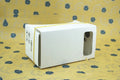 Pink cardboard VR glasses with rubber head strap and 3D lenses for smartphones