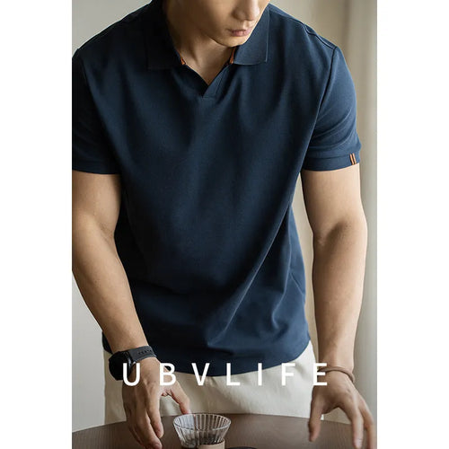 Blue short-sleeved cotton blend polo shirt for men on a hanger, showing regular fit and button placket.