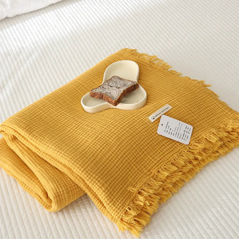 Four-layer gauze cotton blanket with knotted tassels in avocado green colour