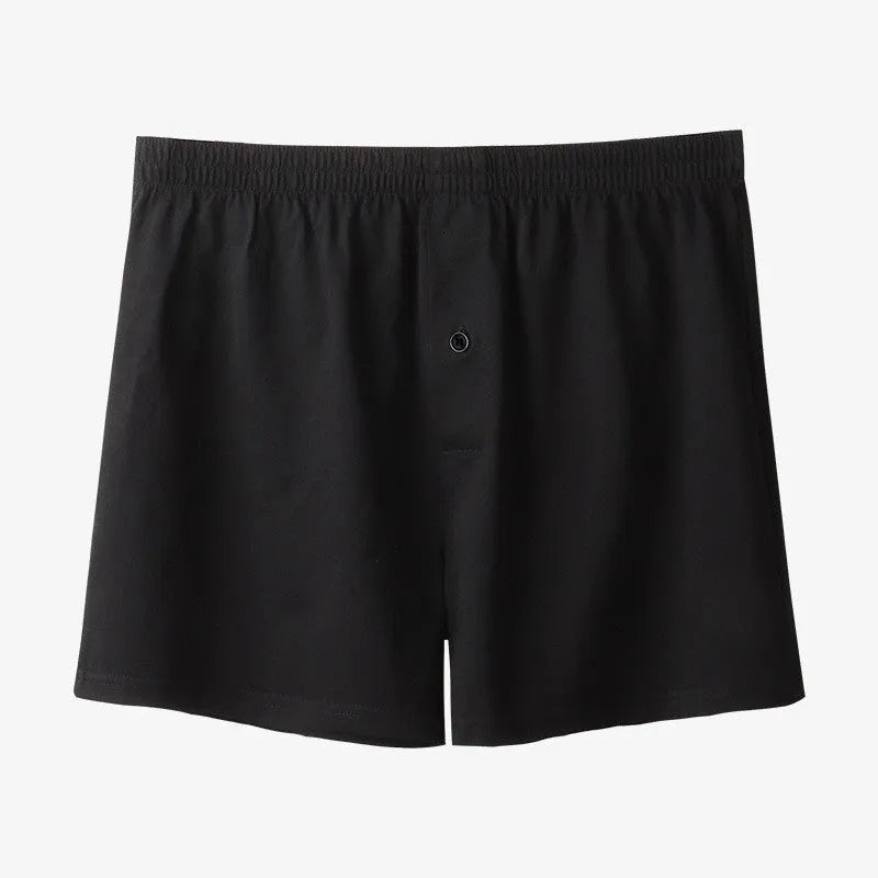 Men's solid colour loose-fit cotton boxer shorts on a white background, showing high waist and leg openings.
