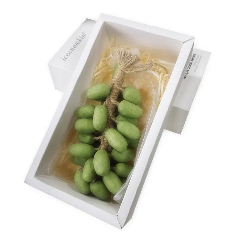 Handmade grape soap bars in black, green, and purple grape scents alongside litchi soap, with gift box and mesh bag packaging