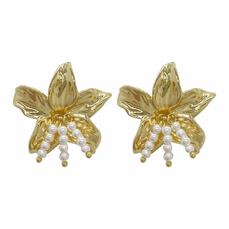 Gold H1795 metal flower earrings with pearls and an exaggerated, personalised design.