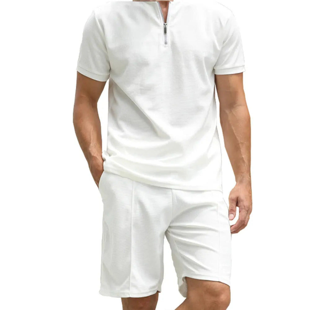 Men's solid colour short sleeve polo shirt and matching trousers two-piece set on a hanger.