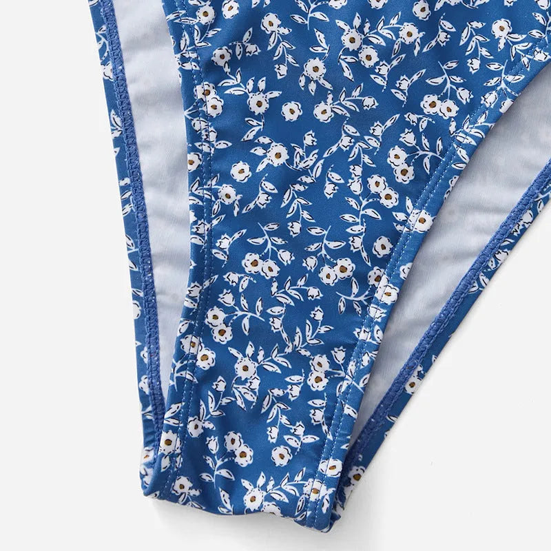 Blue three-piece polyester swimsuit set with top and shorts on a mannequin.