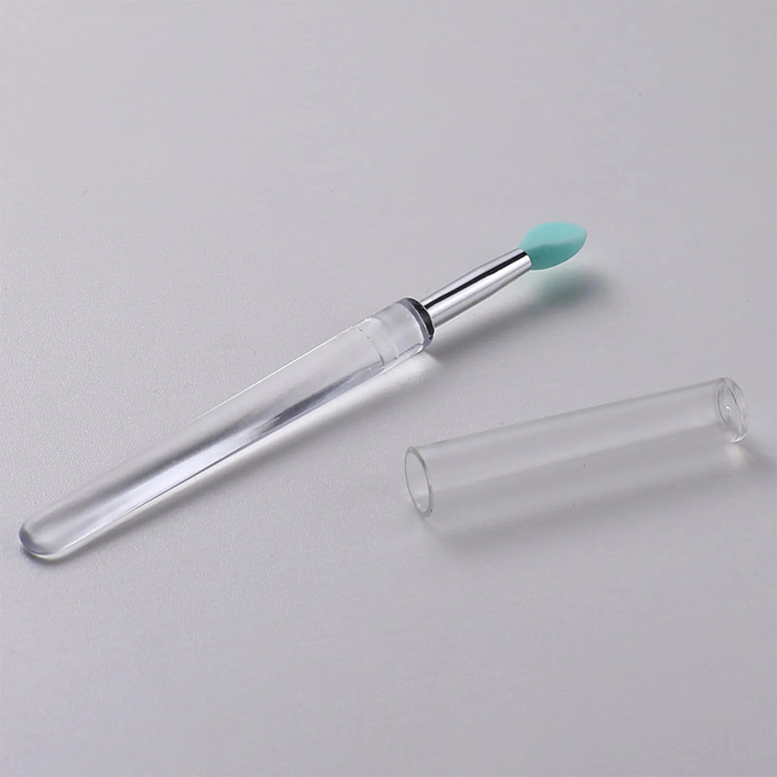 Set of silicone lip brushes with caps in various colours including blue, pink, and purple.