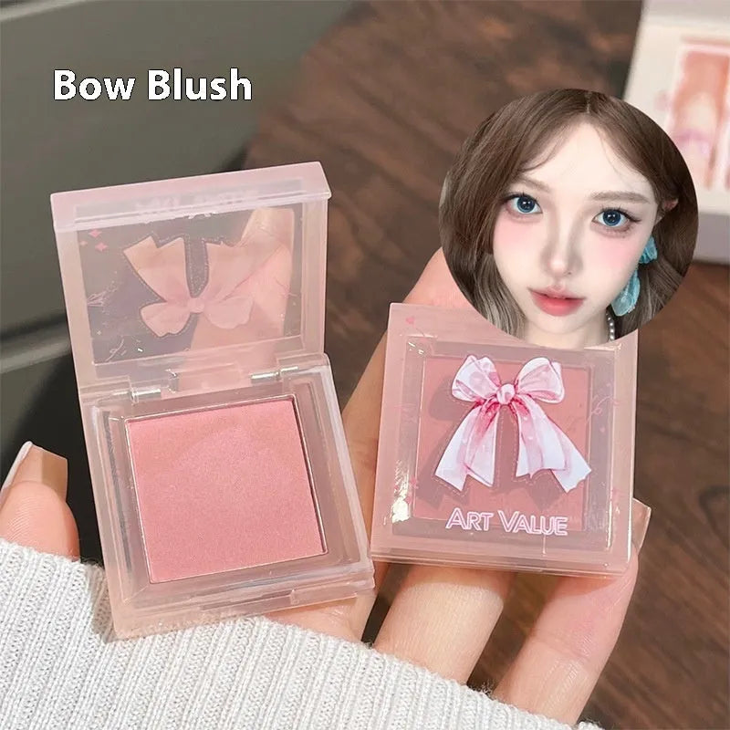 Butterfly Box makeup collection showing pink lip muds, powder blusher and matching necklace
