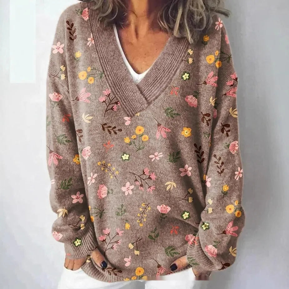 Women's white floral print V-neck sweatshirt with 3D pattern and long sleeves on a hanger.