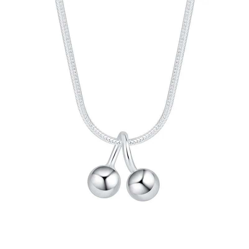 Silver cherry pendant necklace on an adjustable snake bones chain for women.