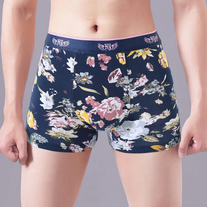 Men's cotton boxer briefs on a white background, showing the U-shaped pouch design and a floral pattern.