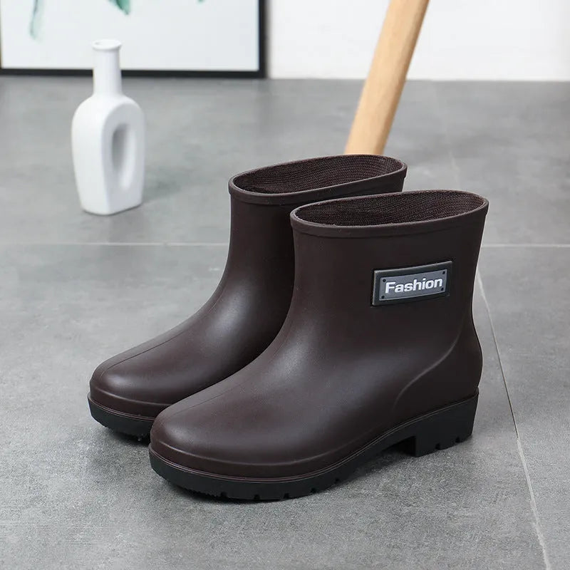 Women's black PVC rain boots with mid-calf height and low heel