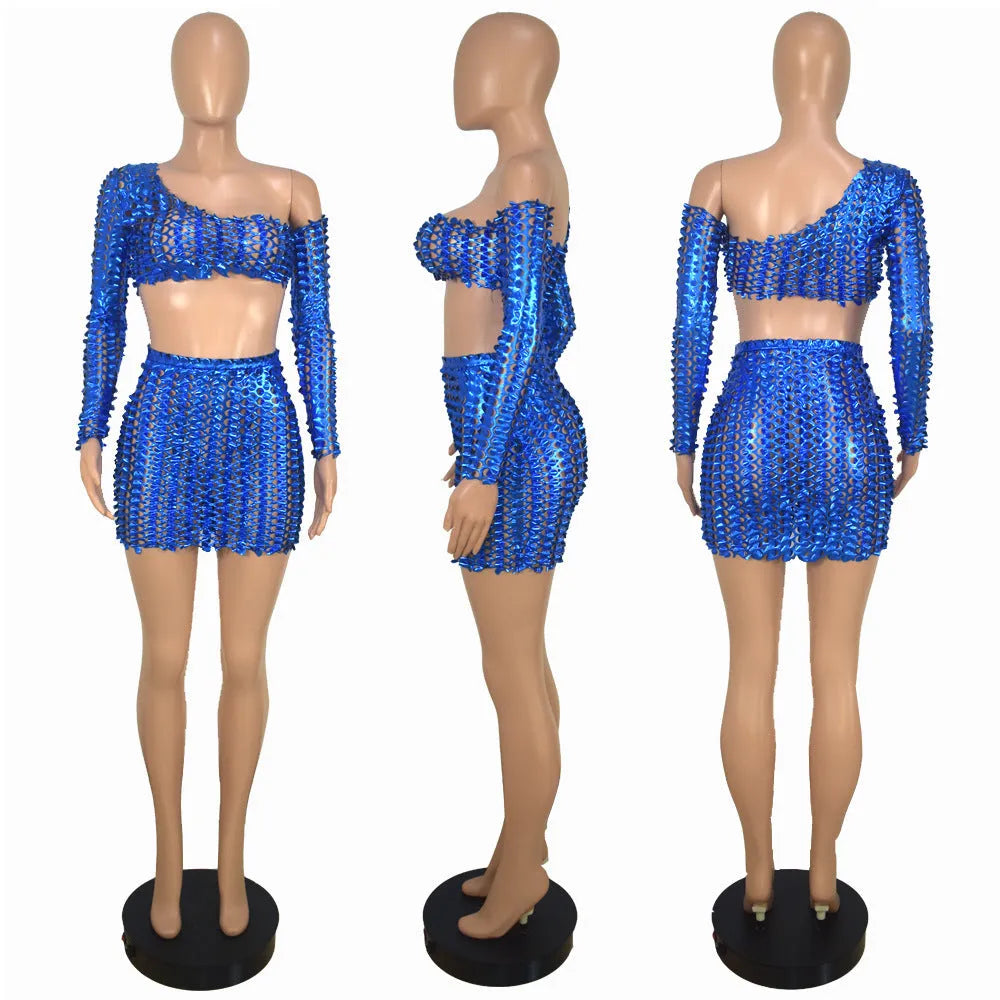 Black hollow-out two-piece dress set with sleeveless top and short skirt on a mannequin.