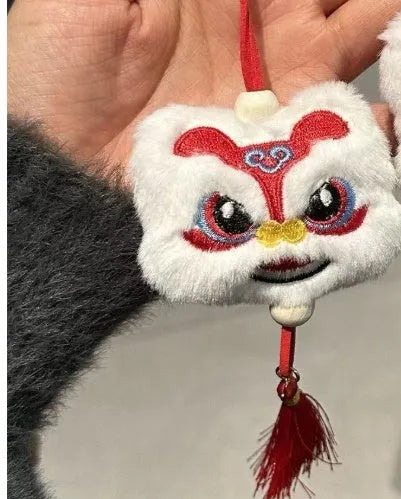 Blue and yellow handmade Chinese plush lion keychain ornament with star stone and long tassel.