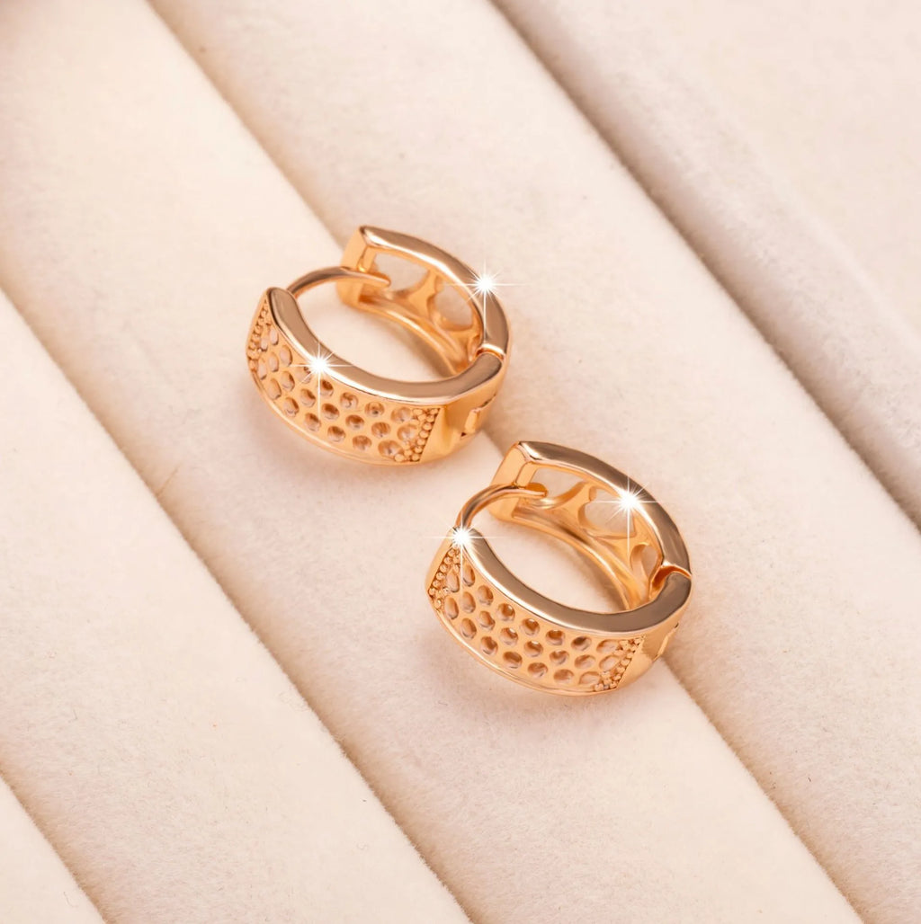 Rose gold electroplated earrings with three hollow heart shapes in circular design