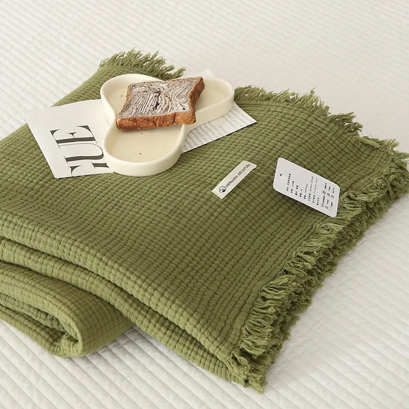 Four-layer gauze cotton blanket with knotted tassels in avocado green colour