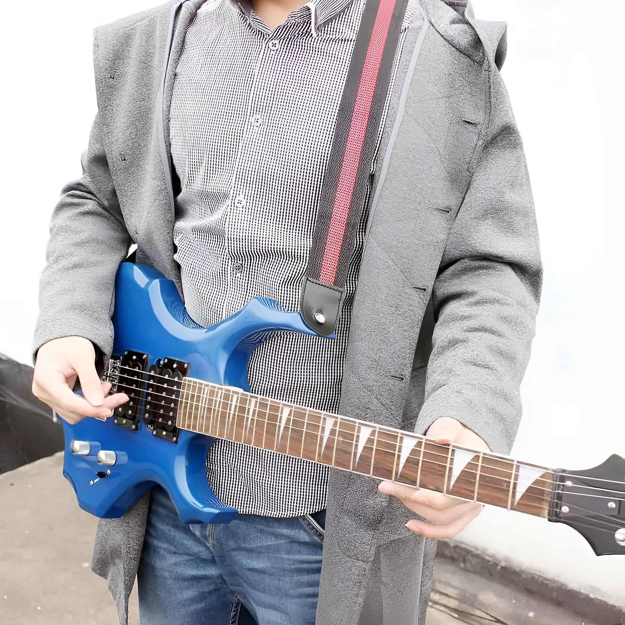 Woven crossbody guitar strap in army green, shown fitted to an electric wooden guitar.