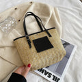Straw woven women's shoulder bag with three-dimensional pockets in black colour option