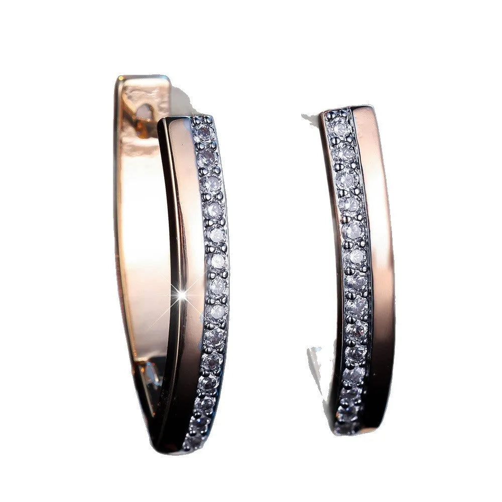 Women's geometric drop earrings with champagne gold electroplating and white diamond accents, showing V-shaped design and clip-on back.