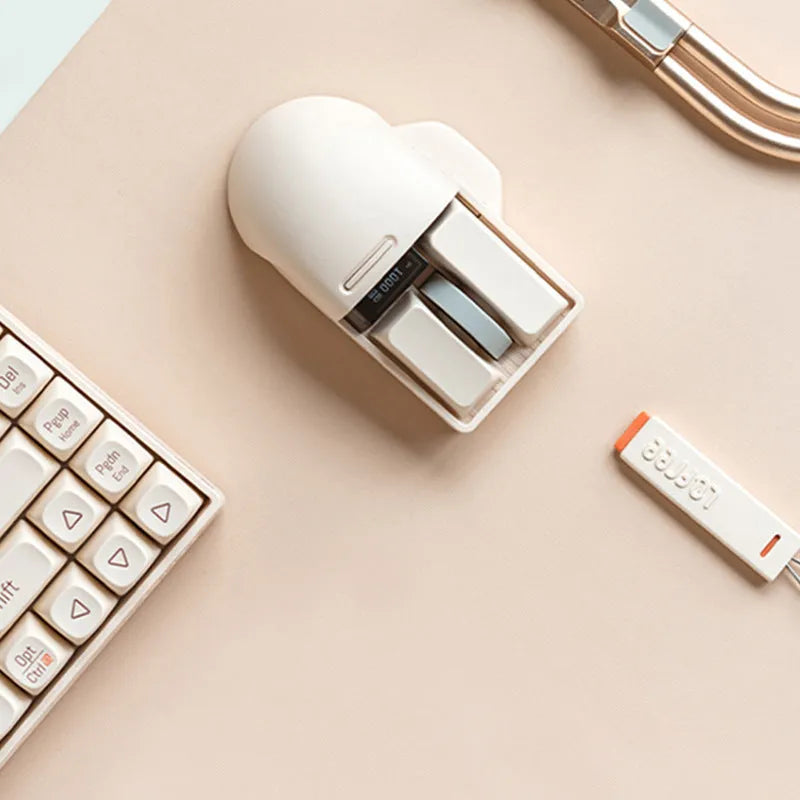 Xiaoqiao tofu-coloured wireless mouse with multiple buttons beside its Type-C charging cable and wireless receiver.