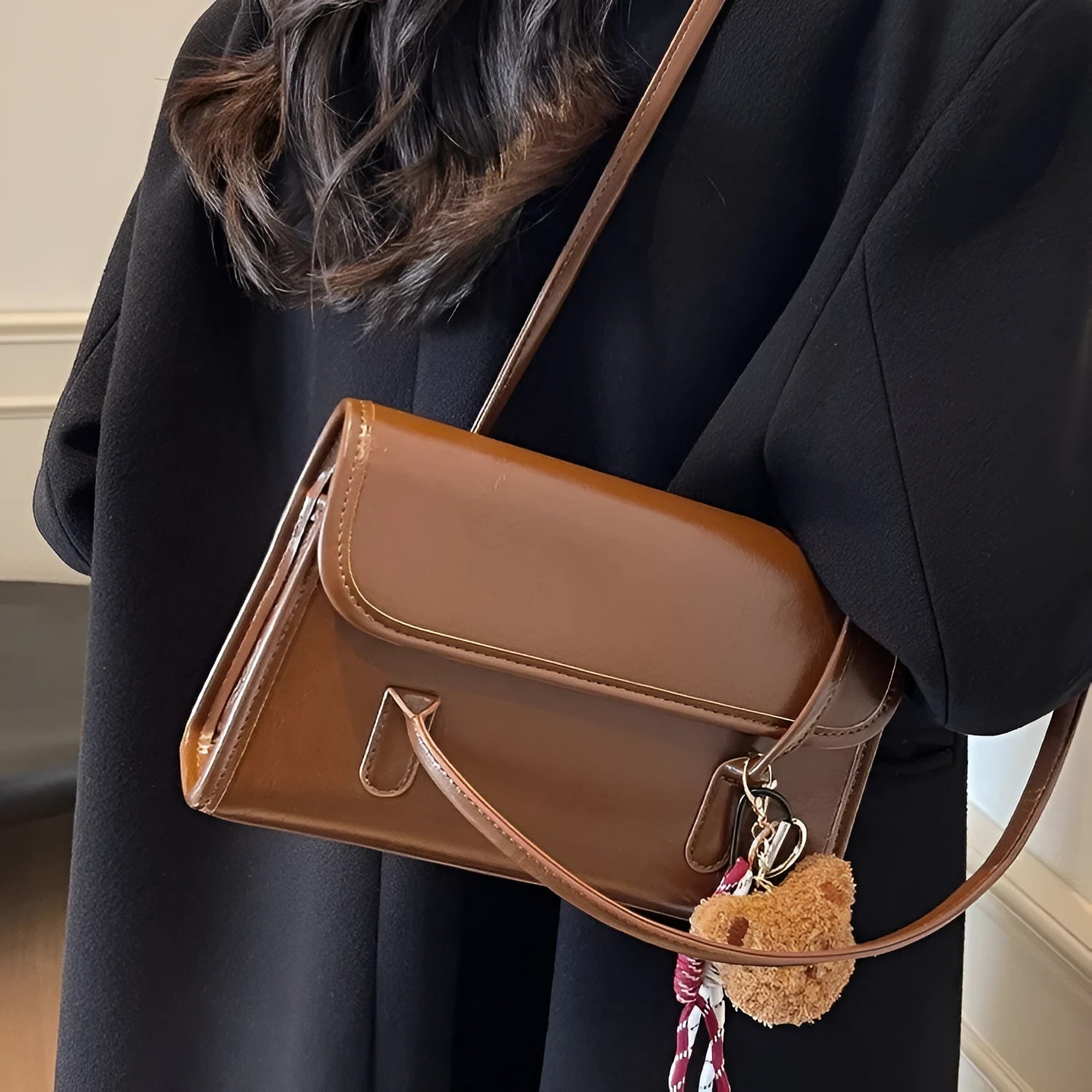 Women's brown PU leather square shoulder bag with pendant accessory showing interior zipper compartment