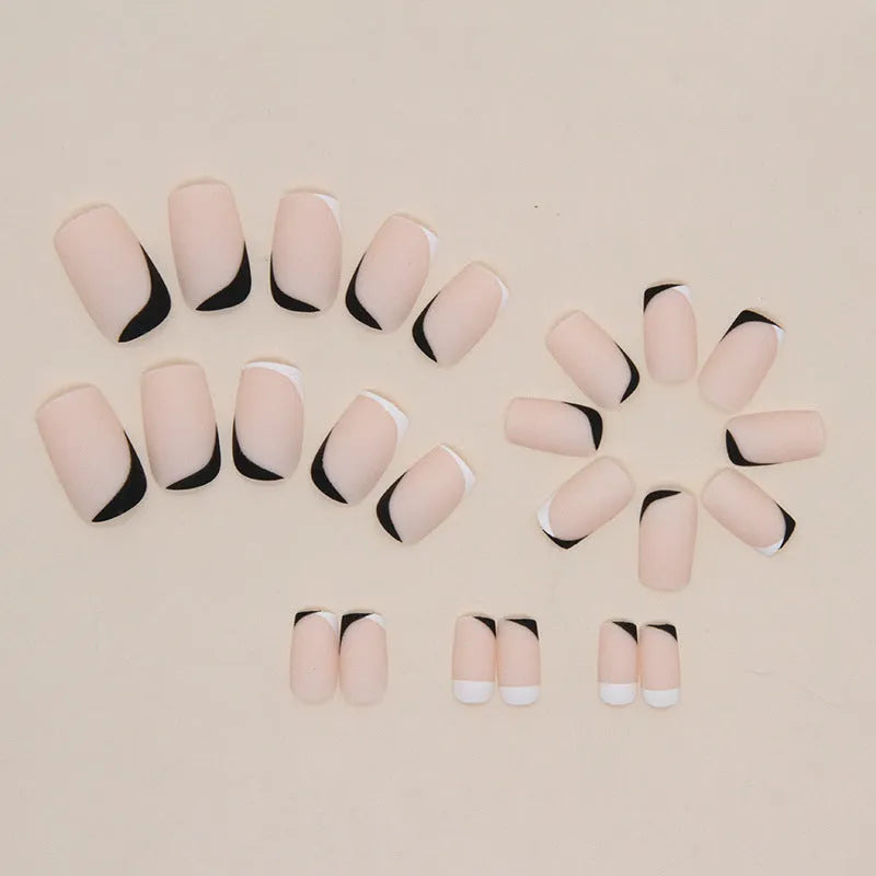 Black and white frosted press-on false nails with French manicure style and plastic wearable armour