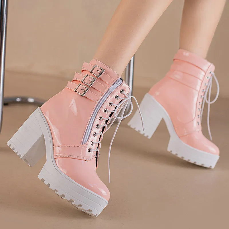 Women's black ankle boots with thick heel, round toe, and front lace-up on a waterproof platform sole.