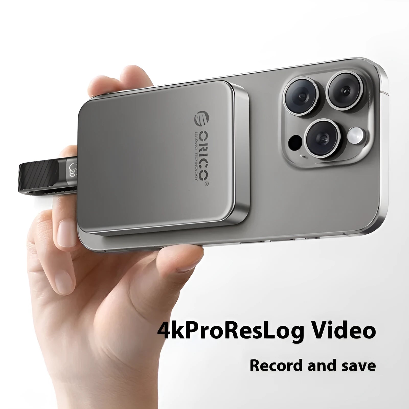 Grey magnetic mobile solid state drive with C to C cable and magnetic ring on a dark surface.